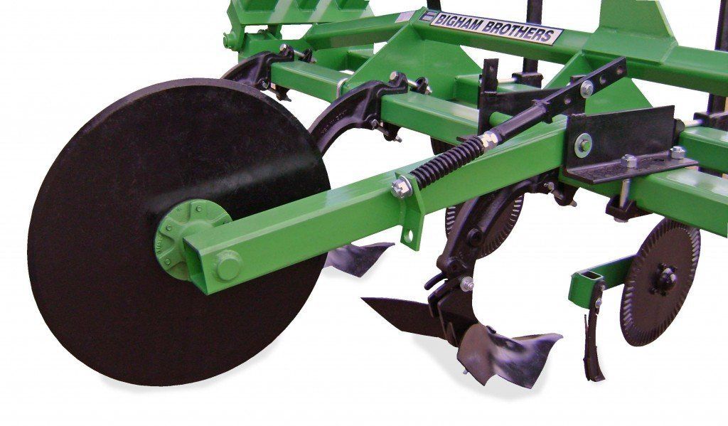 A close up of a green and black tractor on a white background