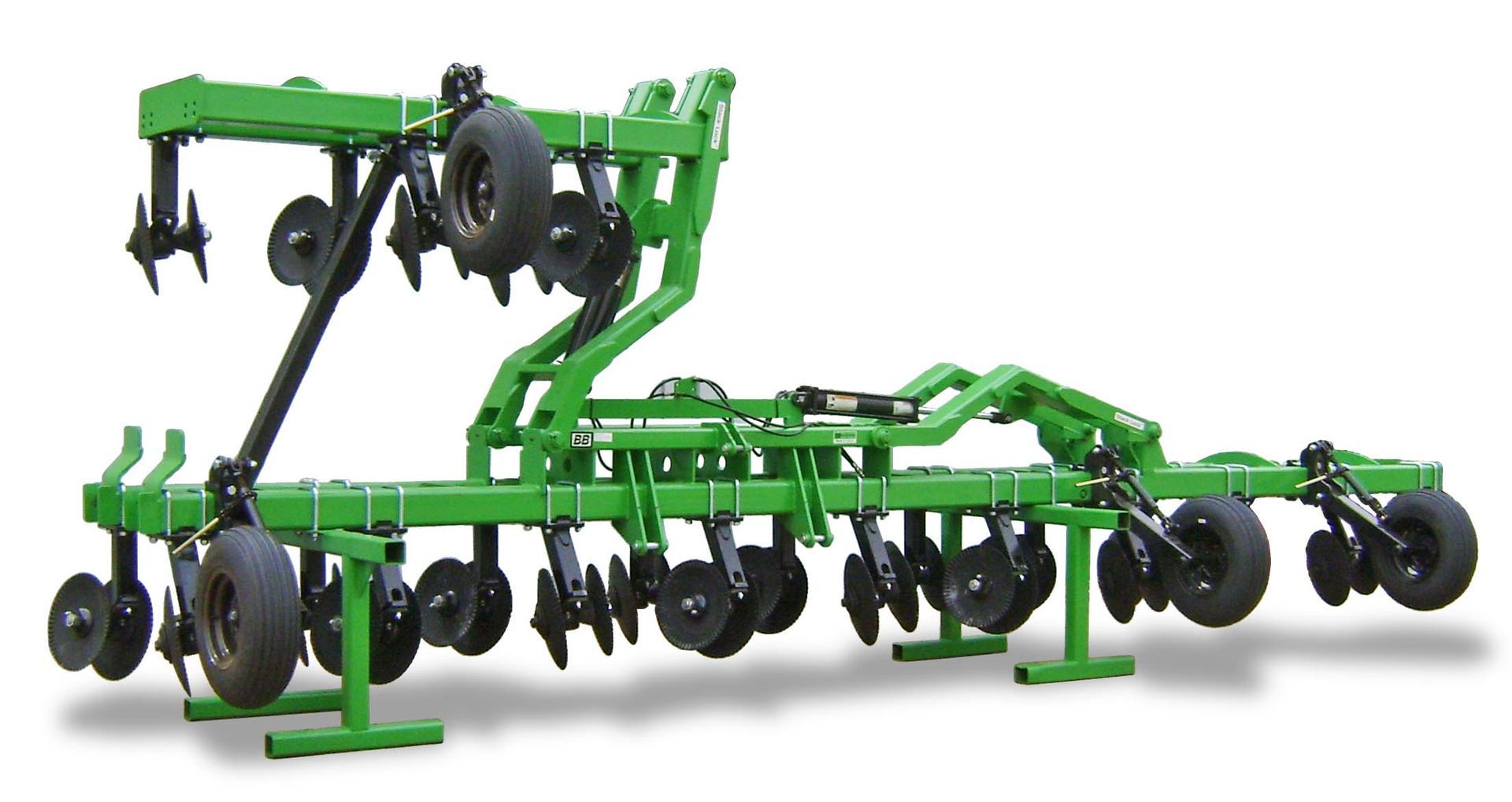 A green tractor with a lot of wheels on it