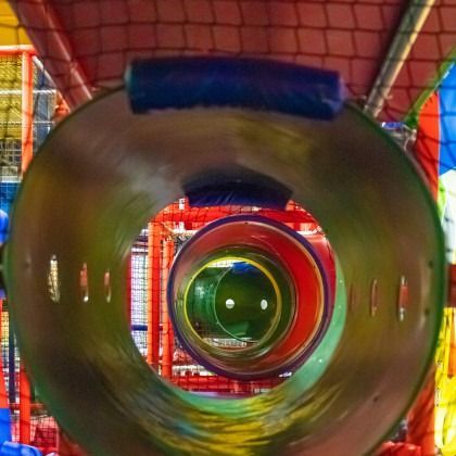 Colorful indoor play tunnel viewed through concentric circular openings