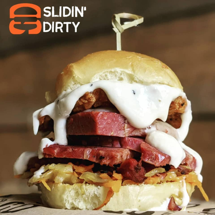 A messy, layered slider sandwich with a