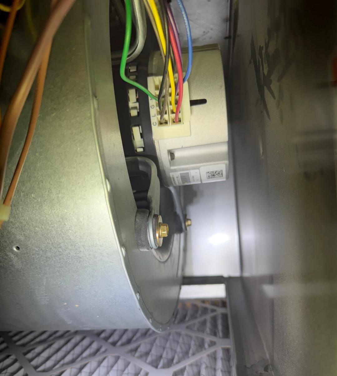 Close-up of exposed electrical wiring and a metal component inside a machine or appliance.