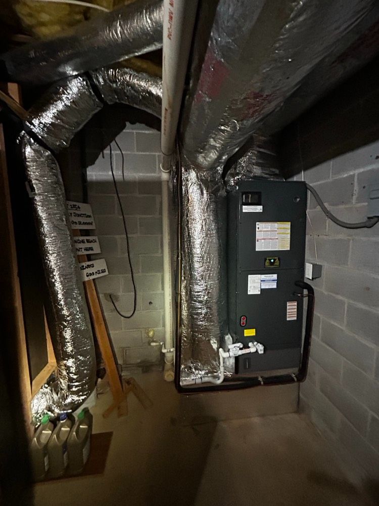Black insulated HVAC ducting inside a ceiling space