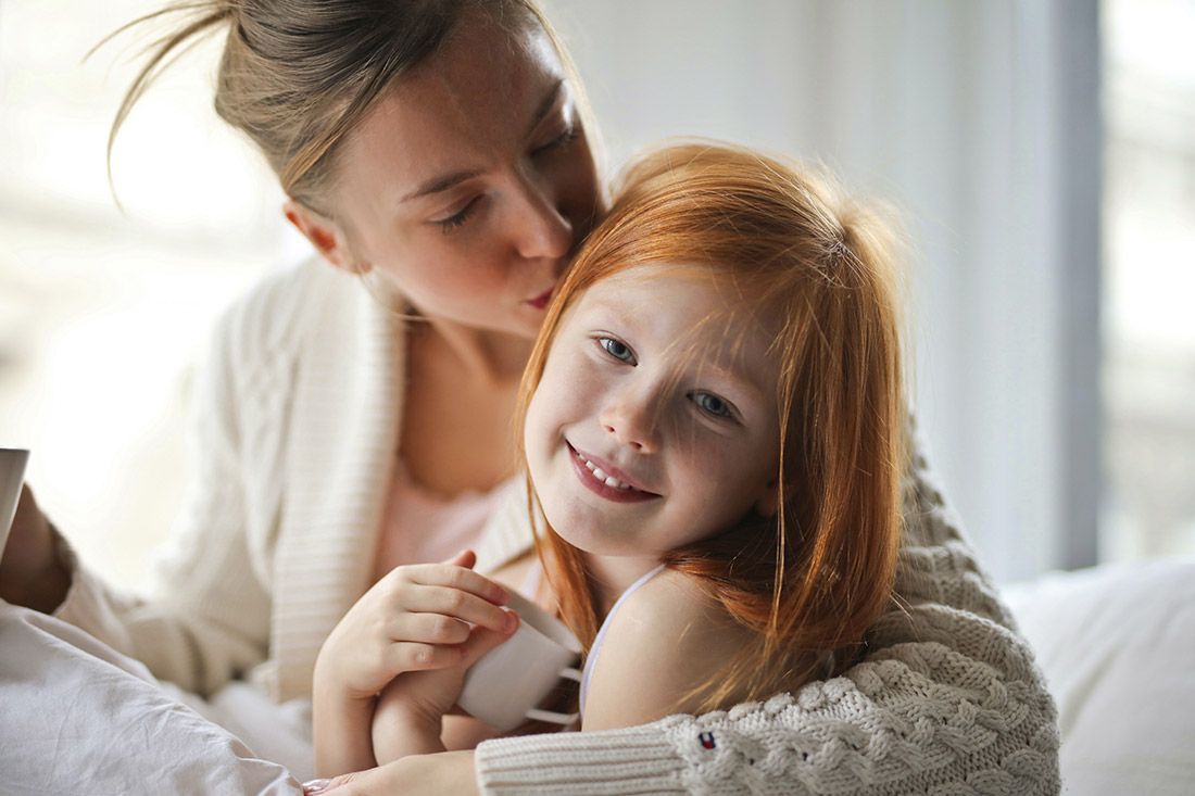 A Mother Kissing Her Daughter - Autism + Child Girls Talking - Autism + Support
