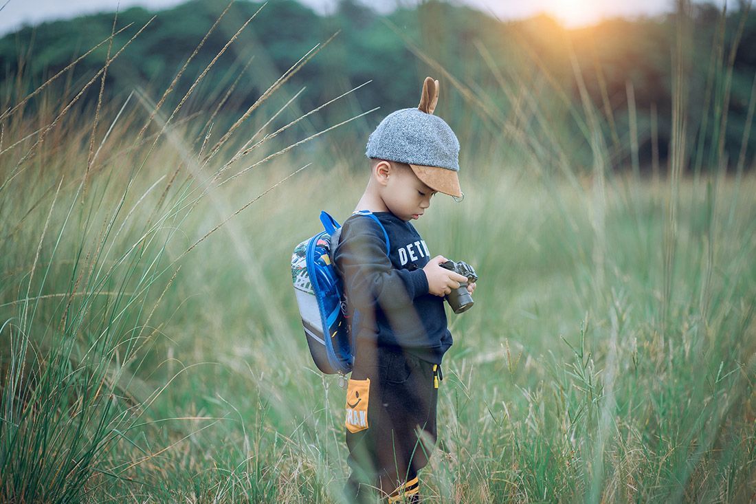 A Toddler Holding a Camera - Autism + Support