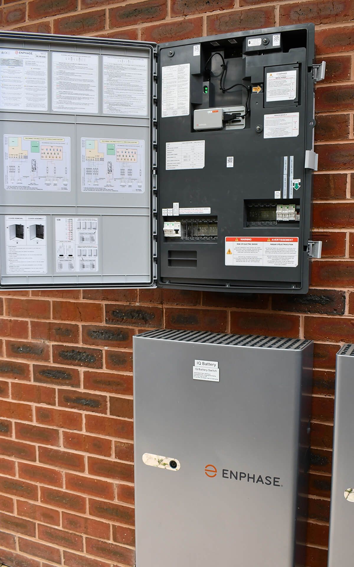 A brick wall with an enphase battery installed