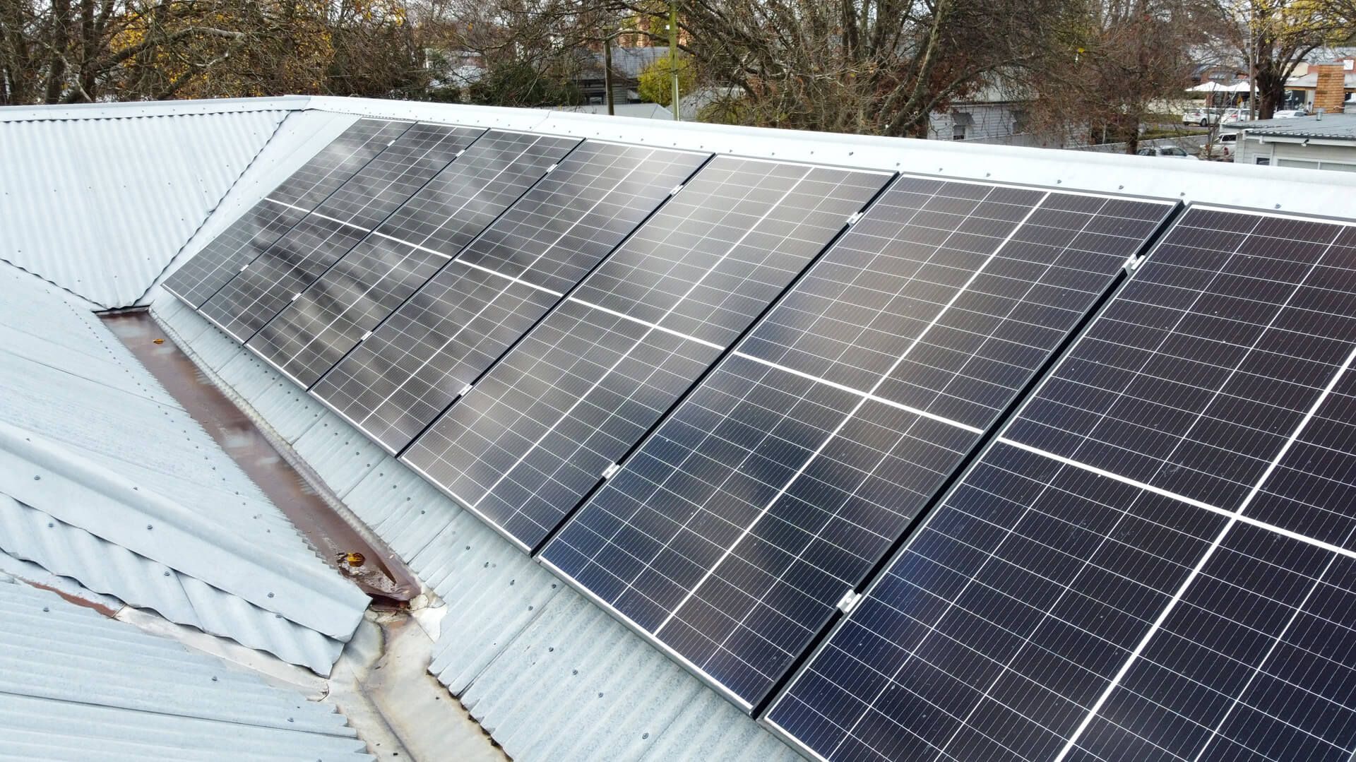 A row of solar panels on the roof of a building in Ballarat.