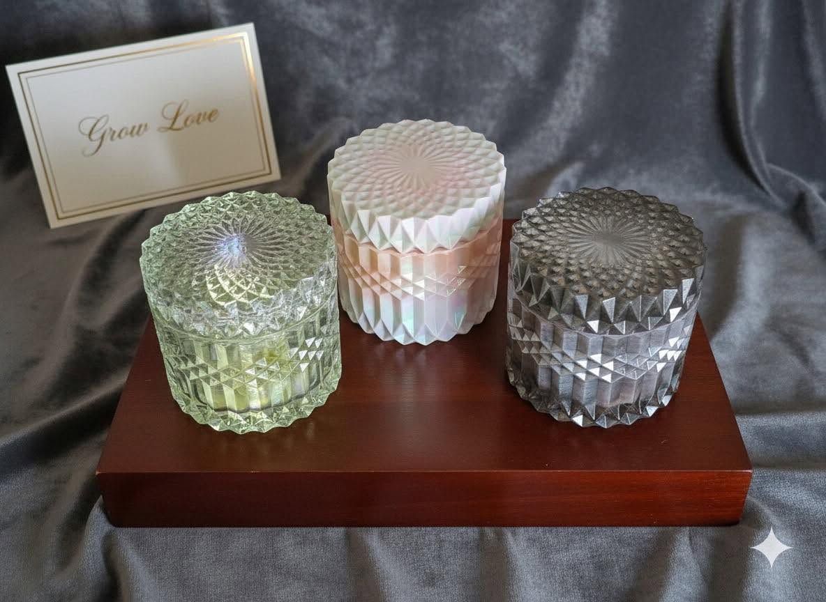 Three decorative glass jars on a wooden tray with a “Pure Love” card against gray satin fabric