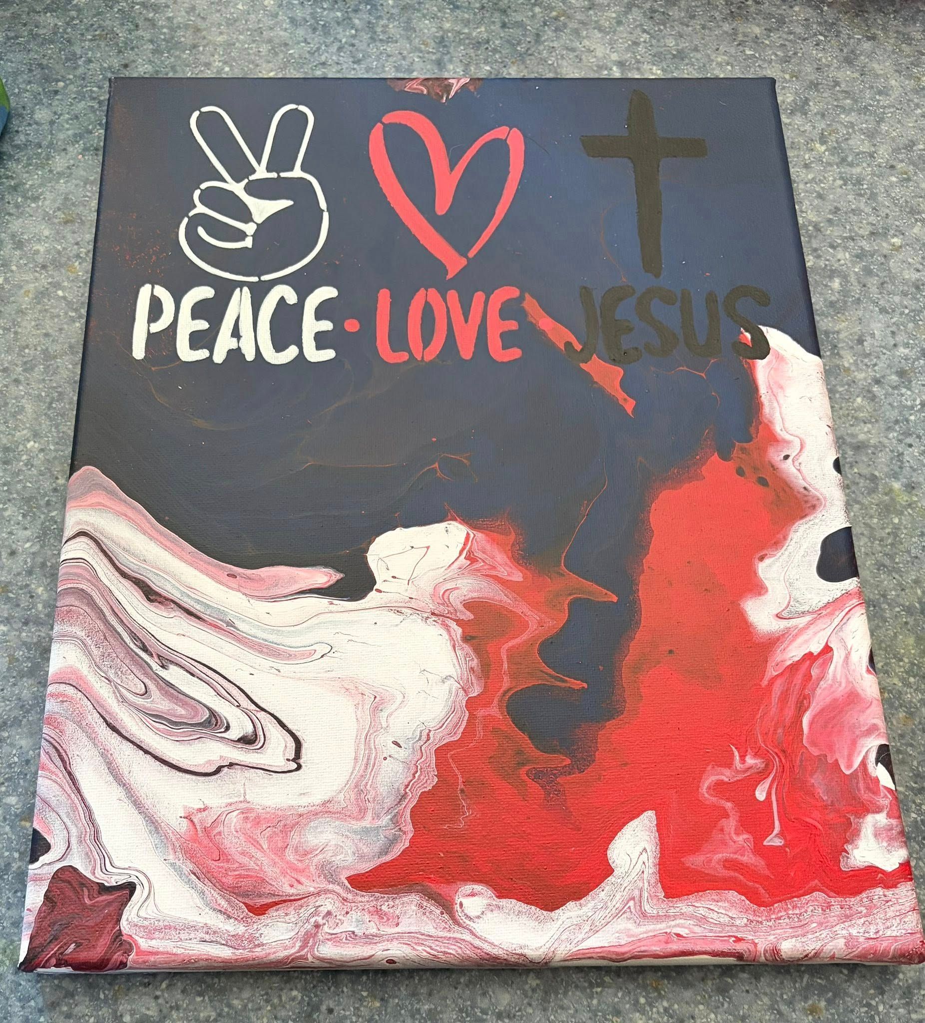 Canvas painting with “PEACE LOVE JESUS,” peace sign, heart, cross, and red-white abstract swirls