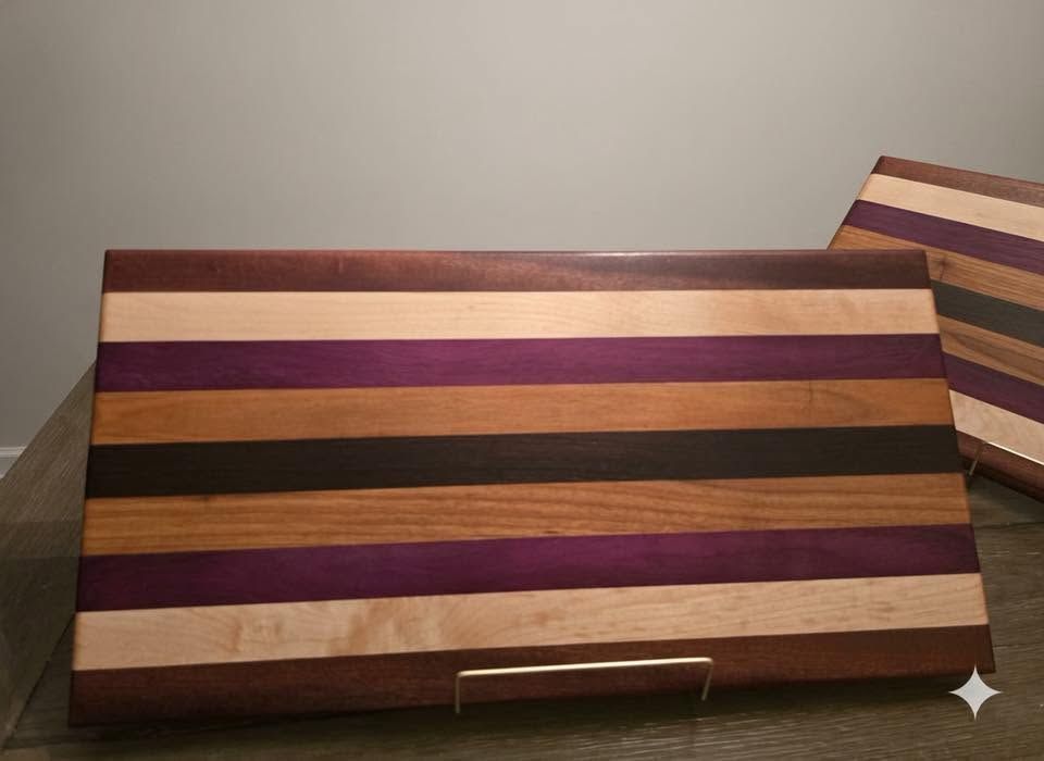 Striped wooden box with beige, purple, orange, and black bands on a tabletop