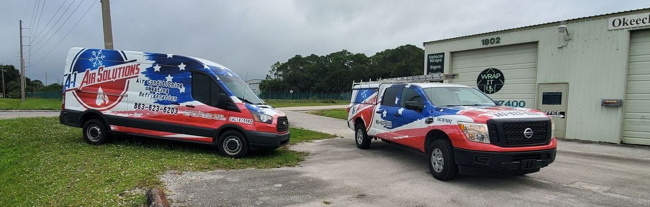 Two vehicles with patriotic paint jobs parked in front of a building.