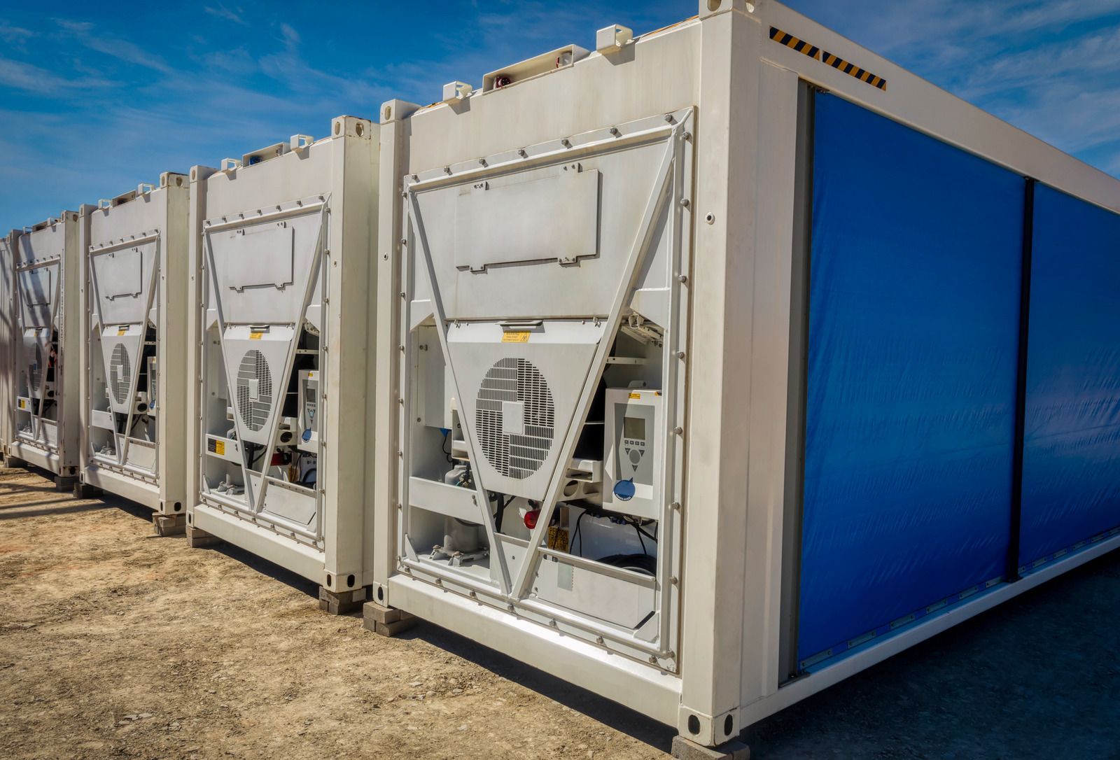 White modular units with blue panels, outdoors.