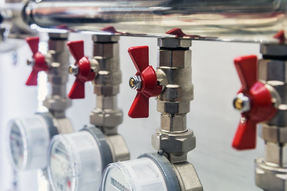 A Row of Water Valves with Red Handles — Nuflow Wide Bay in Bundaberg South, QLD