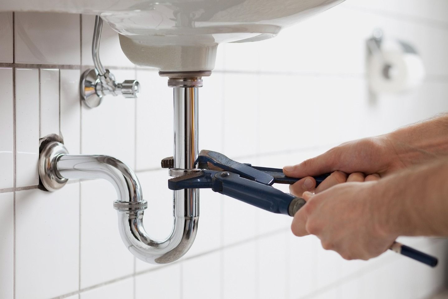 A Person Using Wrench to Repair Sink — Nuflow Wide Bay in Bundaberg South, QLD
