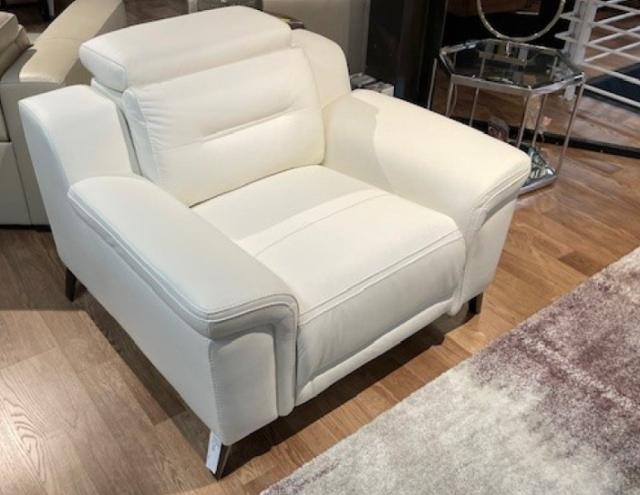 White leather sofa in a furniture store setting.