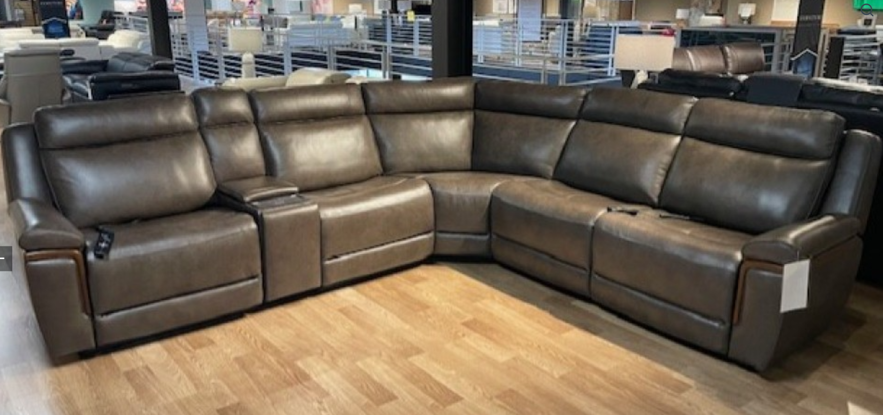 Brown leather sectional sofa in a furniture store.