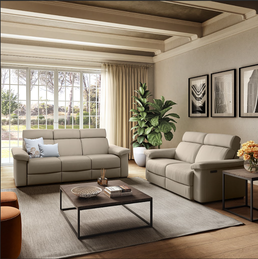 Cream-colored, three-seat reclining sofa on a white background.