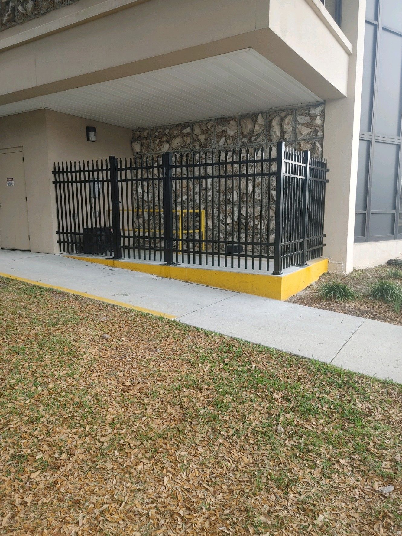 Black metal fence was installed for a business