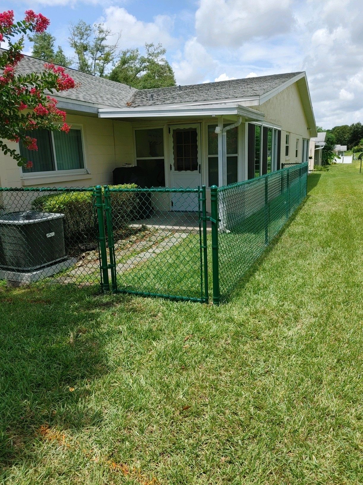 Green residential chain link fence installation