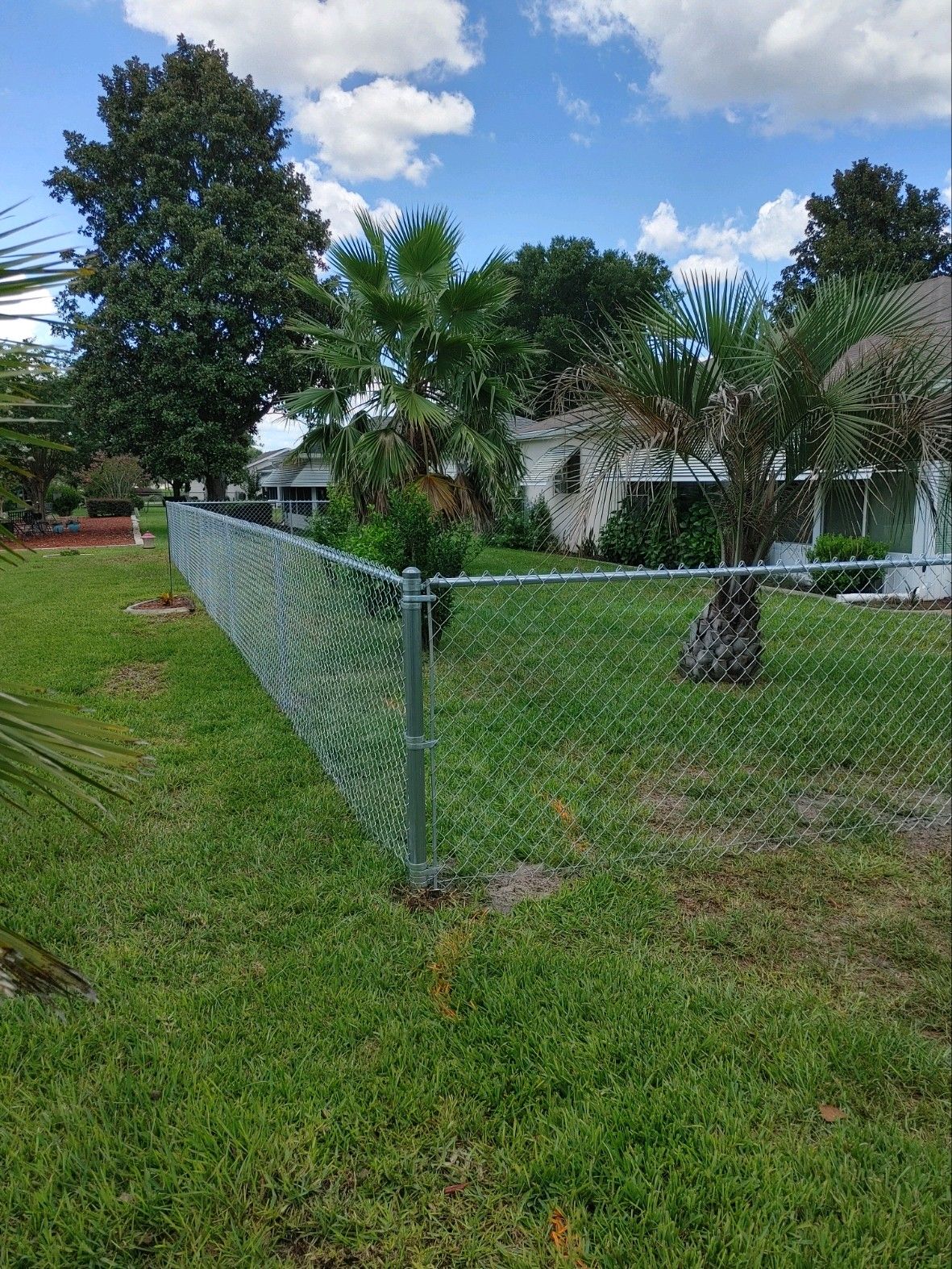 Residential fence installation with chain link, corner view