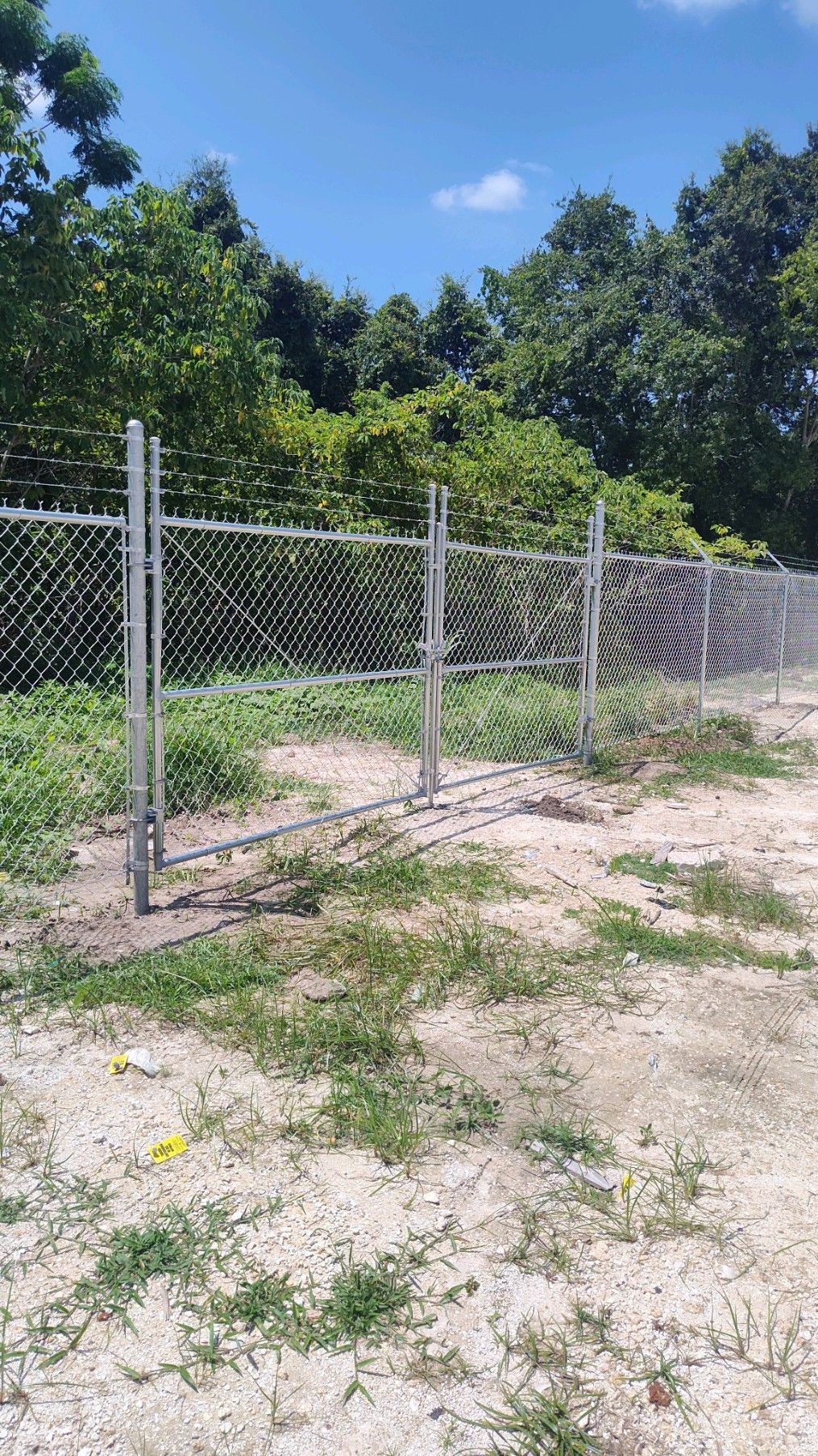 Commercial fence installation with barbed wire on top