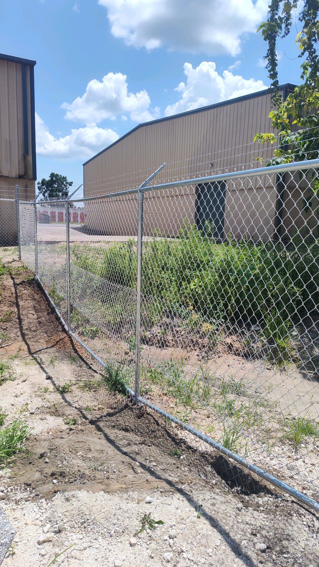 Chain link fence with barbed wire on top
