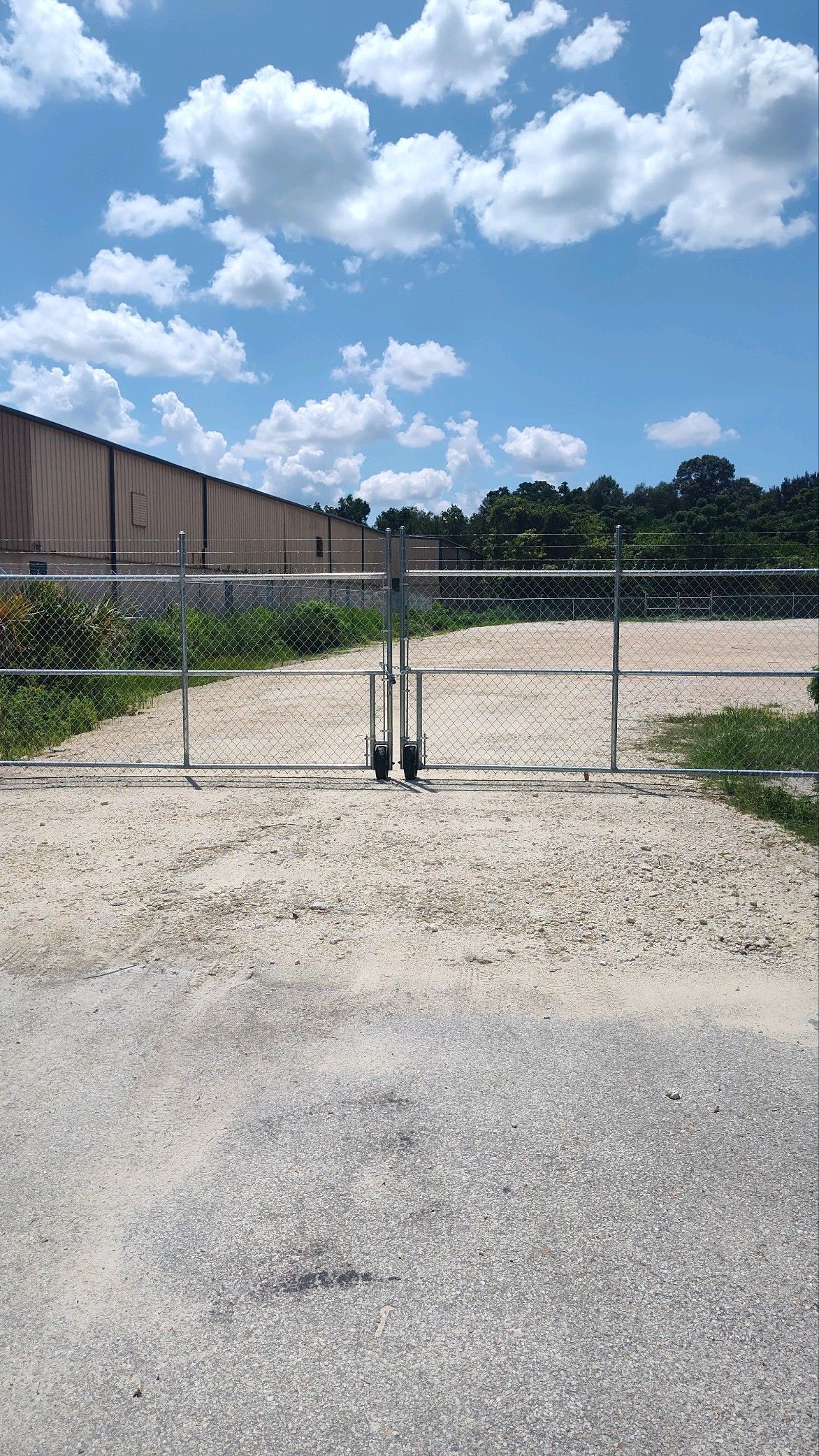 Commercial chain link fence with wheels and barbed wire on top