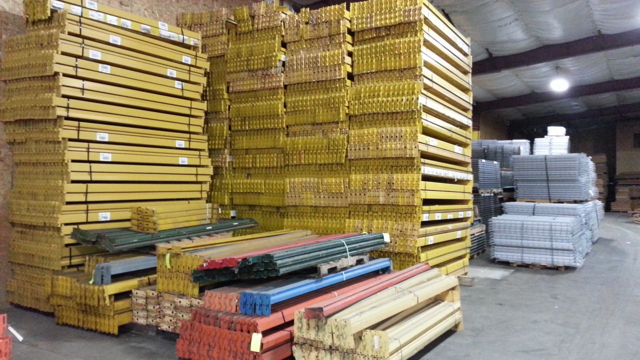 A warehouse filled with lots of wooden beams and pallets.