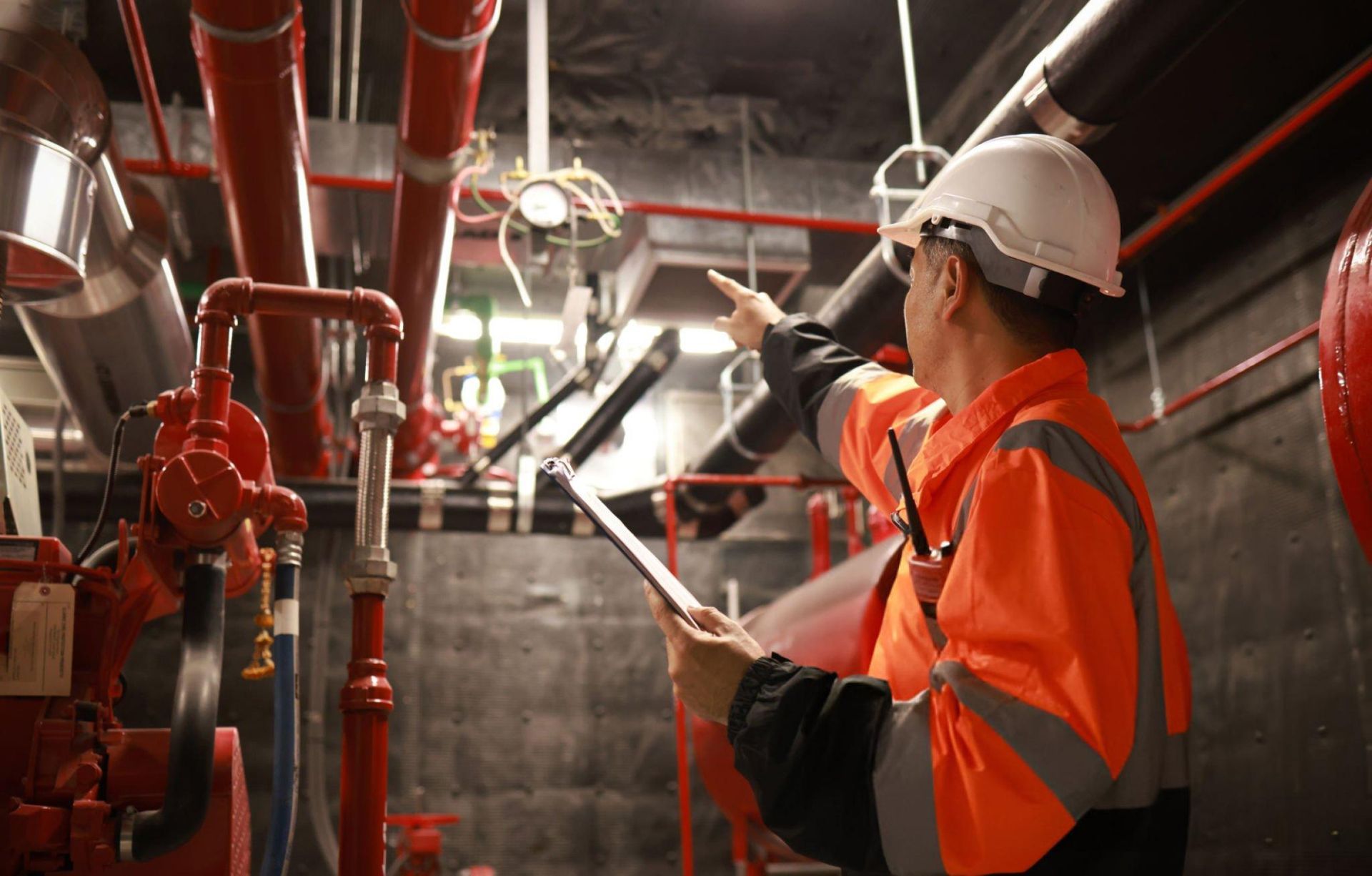 An engineer inspects the safety equipment on a fire extinguishing system. An engineer inspects the safety equipment on a fire extinguishing system.