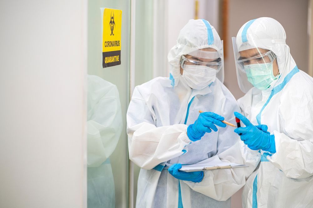 ovid-19 blooding tube wearing ppe suit and face mask in hospital