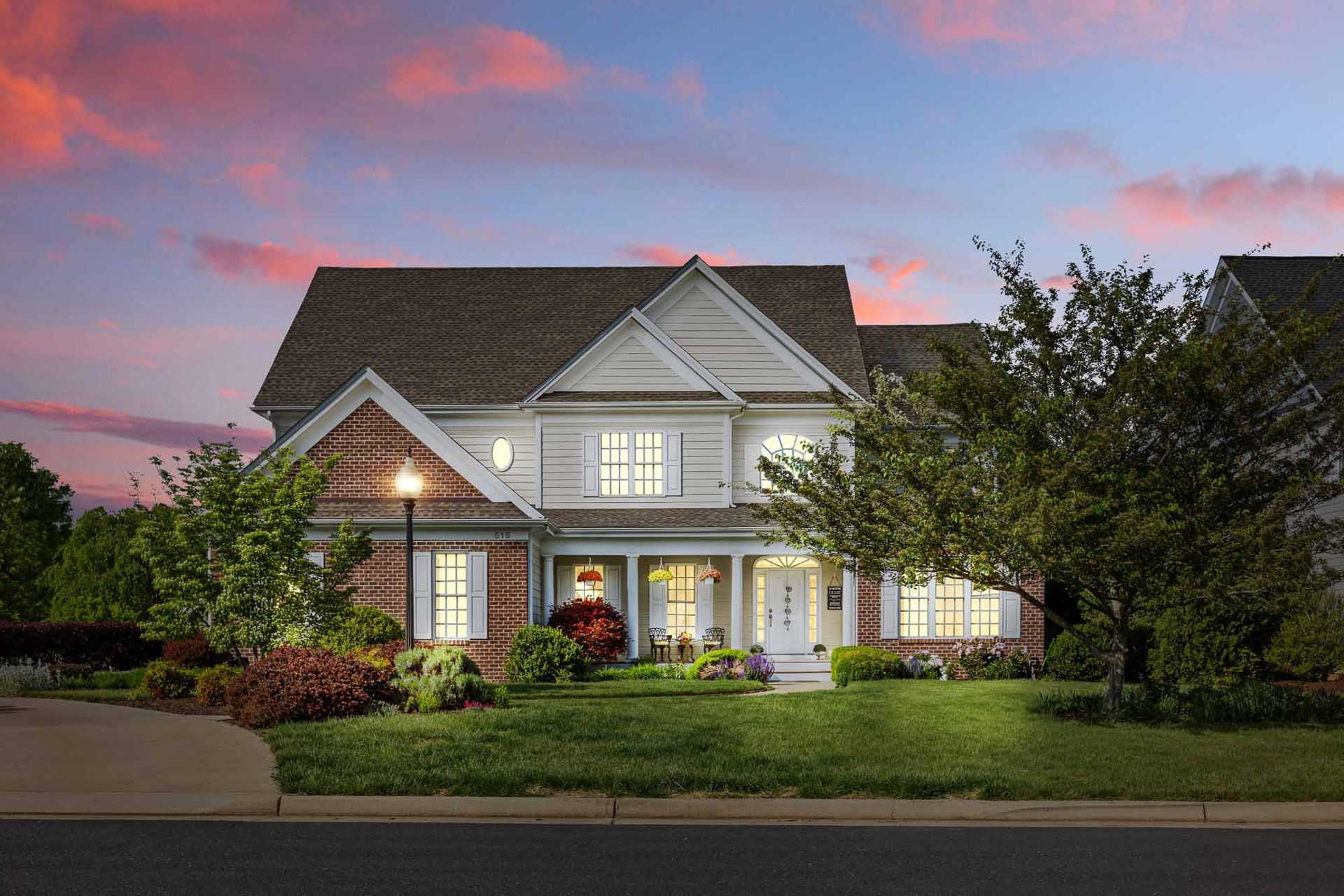 Front elevation at dusk with warm interior light