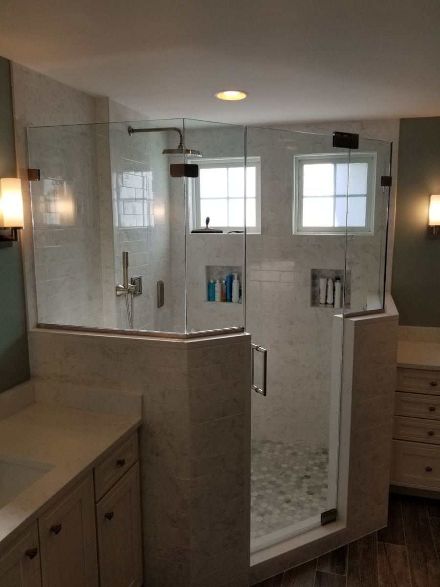 A bathroom with a walk in shower and a window