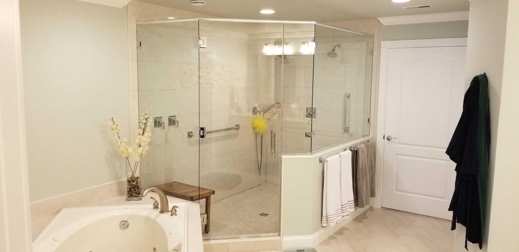A bathroom with a tub , shower , and walk in shower.