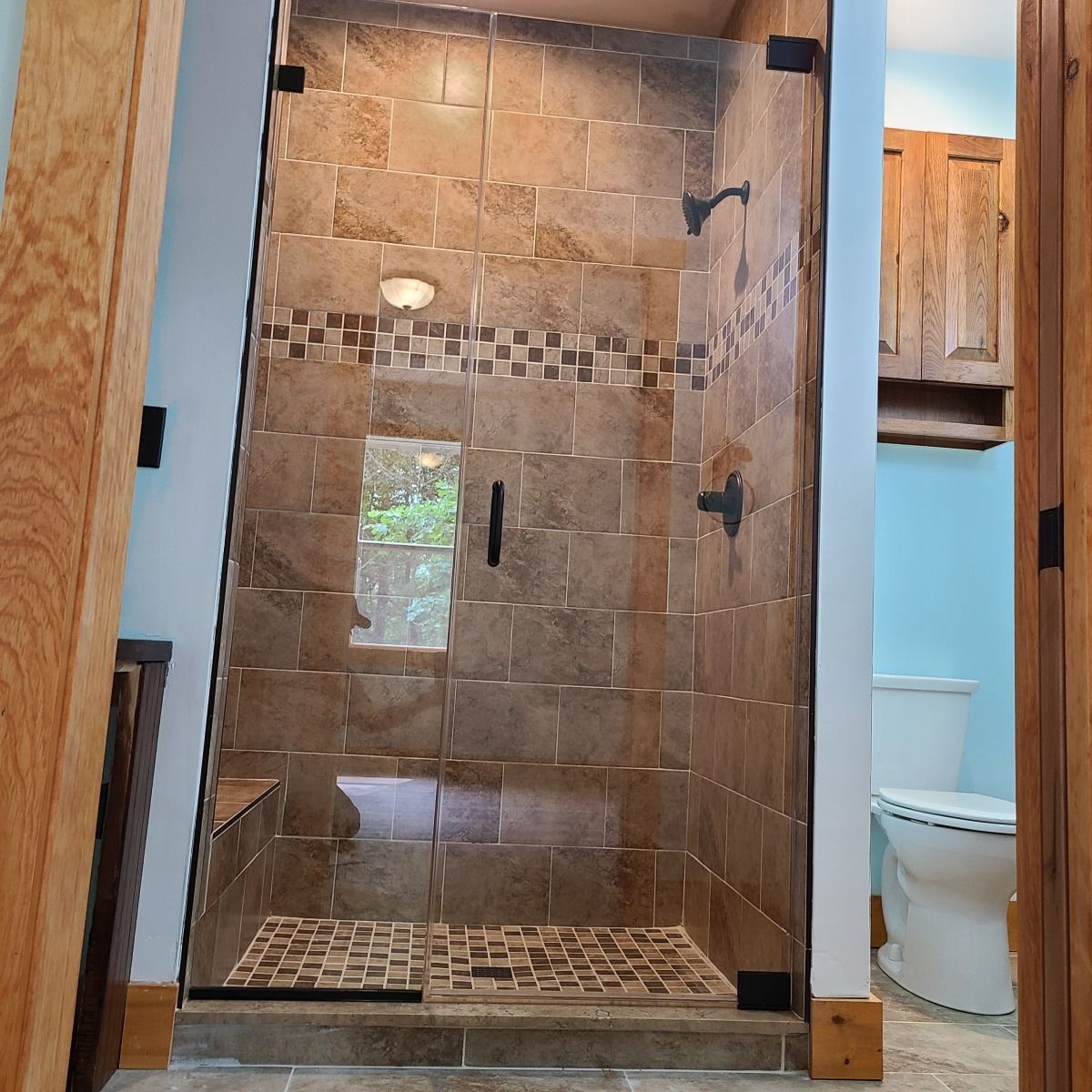 A bathroom with a walk in shower and a toilet