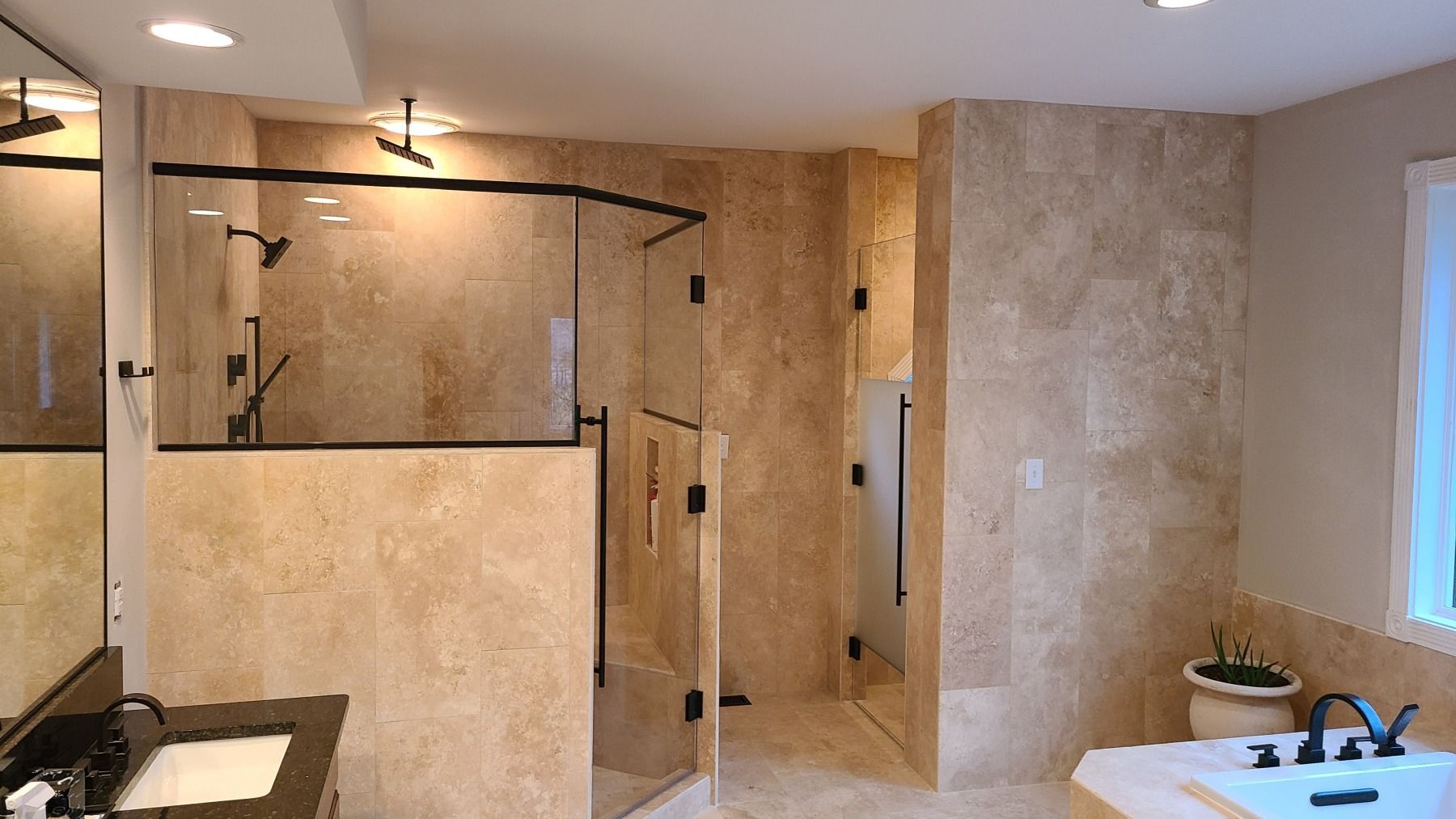 A bathroom with a walk in shower and a bathtub