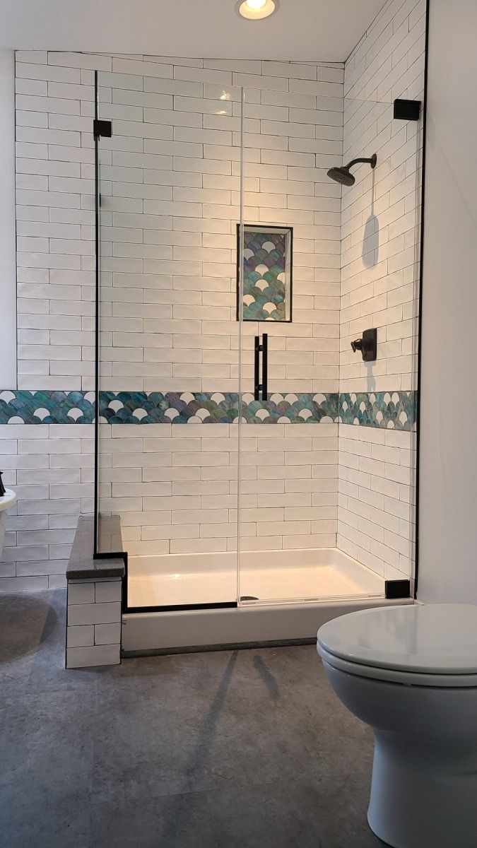 A bathroom with a walk in shower and a toilet