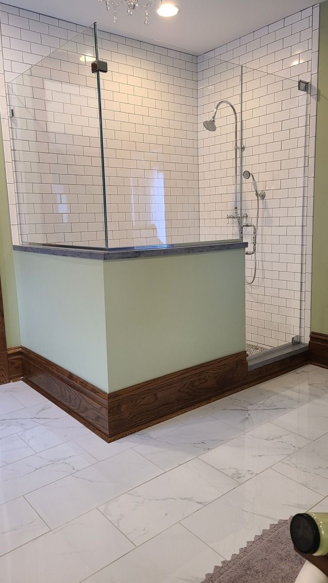 A bathroom with a walk in shower and a bathtub.