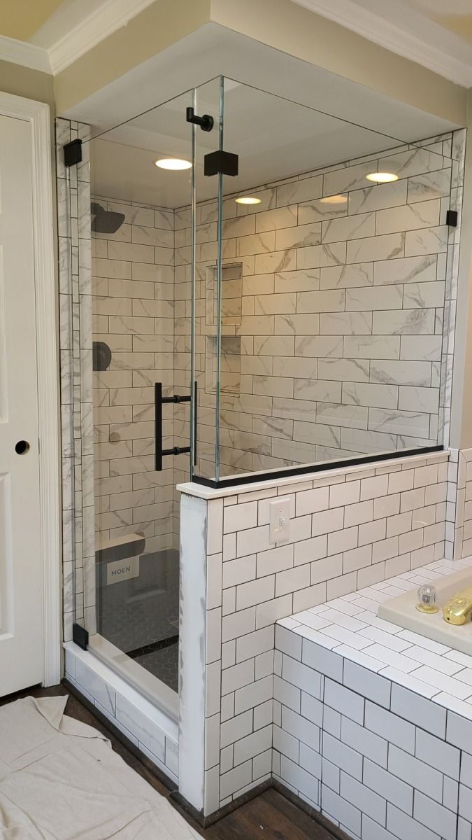A bathroom with a walk in shower and a bathtub.