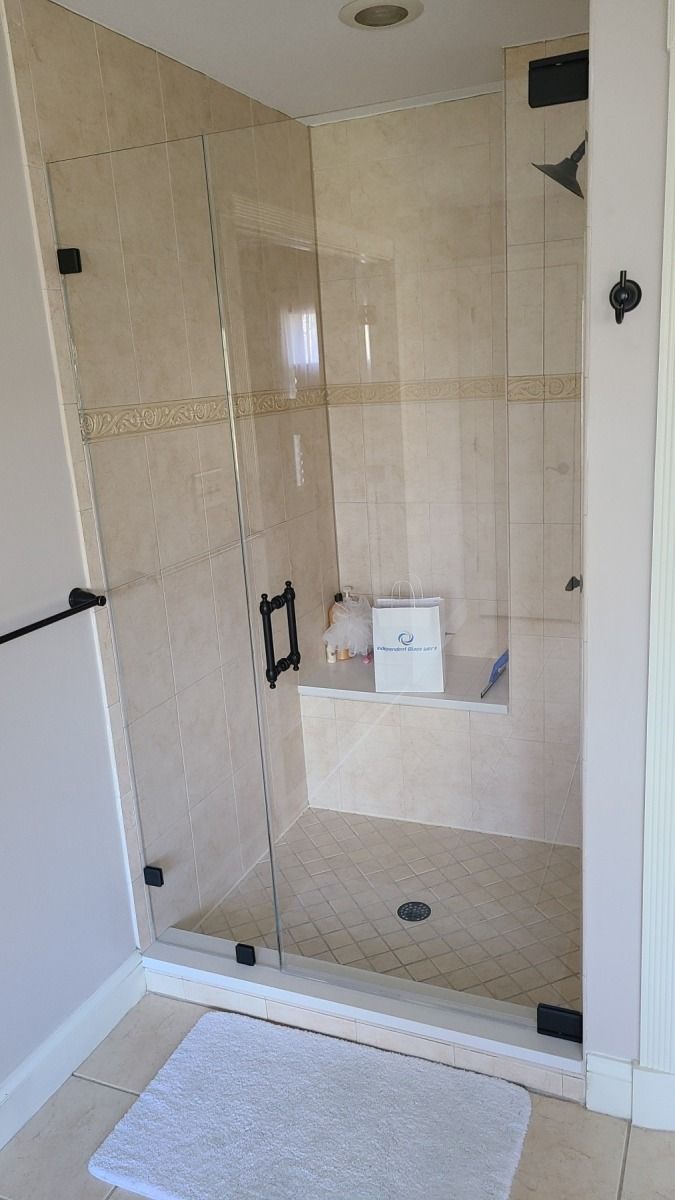 A bathroom with a walk in shower and a bathtub.