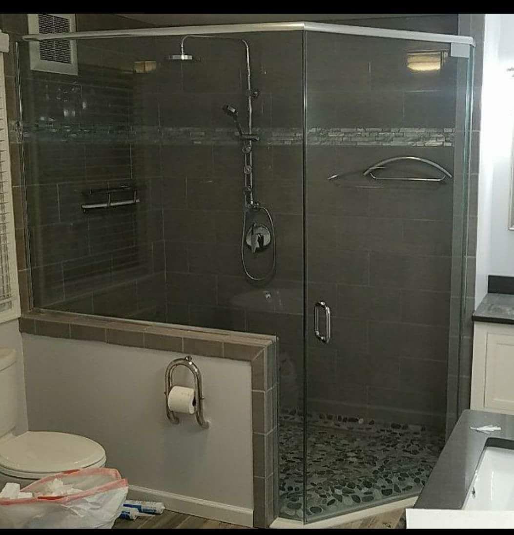 A bathroom with a toilet and a shower with a glass door.