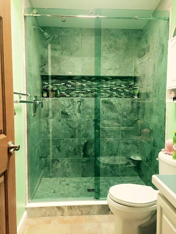 A bathroom with a walk in shower and a toilet.