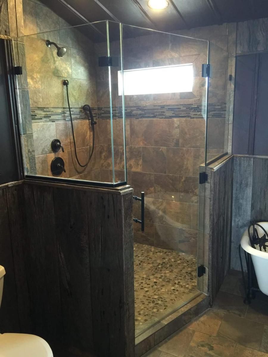 A bathroom with a walk in shower and a bathtub.