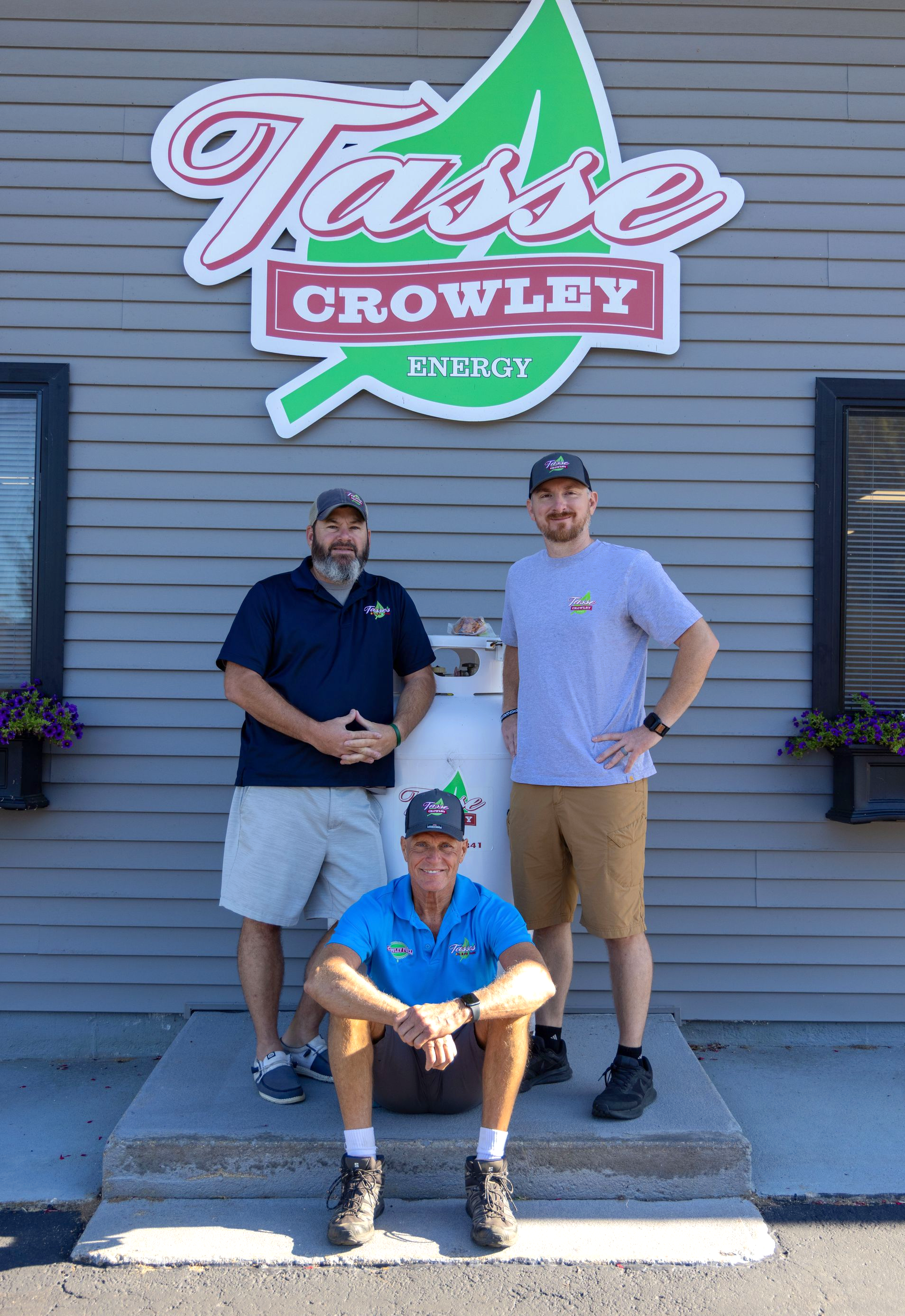 Three men in front of a building with a