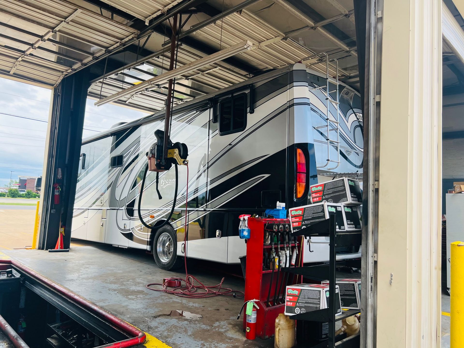 A rv is being worked on in a garage.