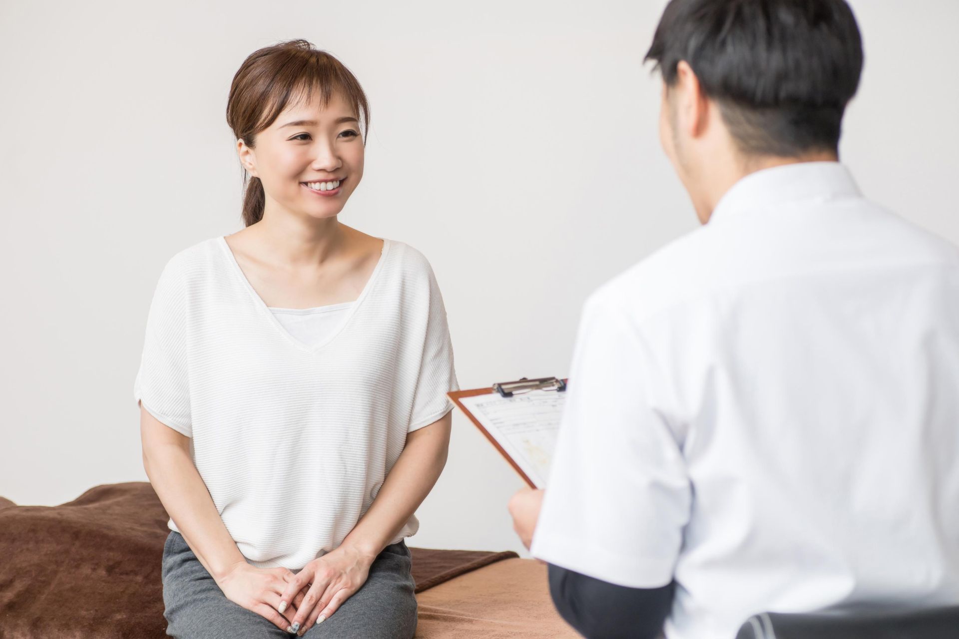 Patient smiling during a consultation with a doctor in a bright clinic room
