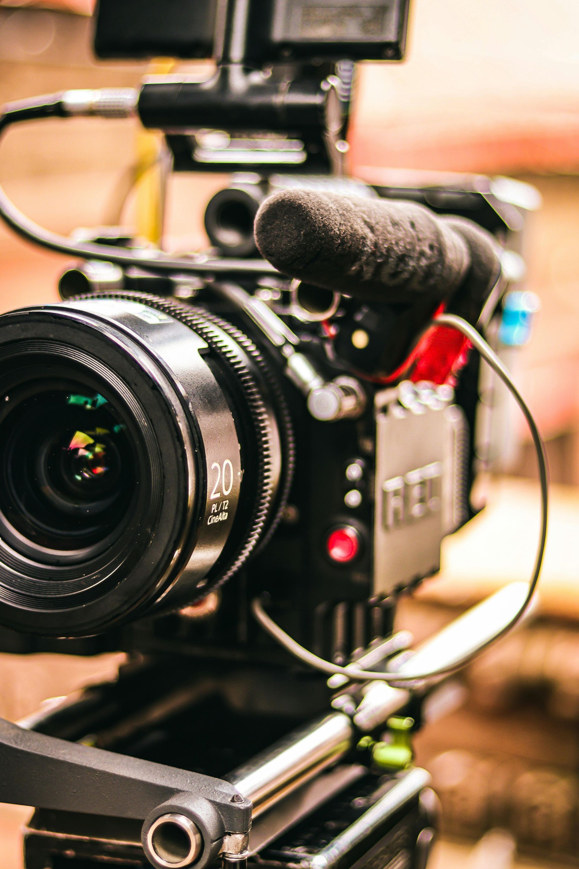 Close-up of a professional video camera with a microphone attached on a tripod