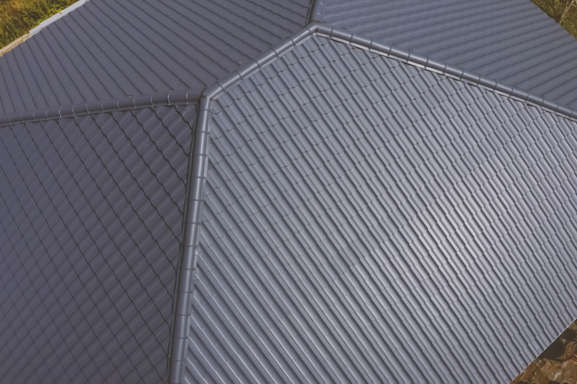 An aerial view of a gray metal roof on a building.