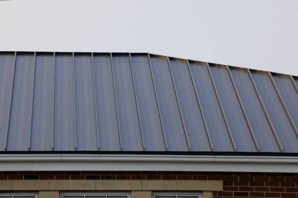 A close up of a metal roof on a brick building