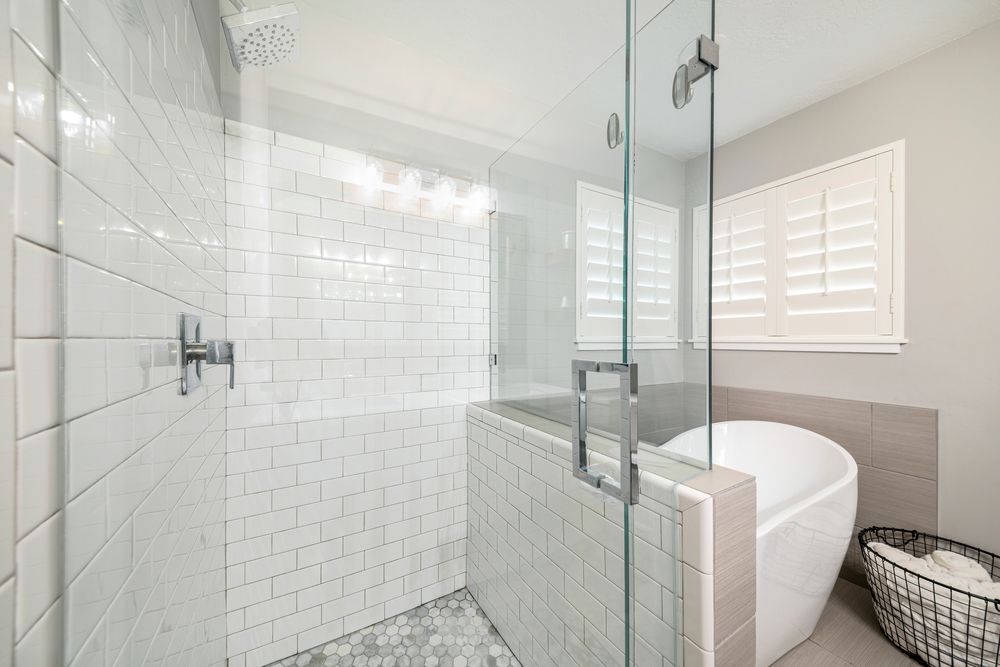 A Bathroom With a Tub, Shower, and Glass Door — Fast Glass & Glazing In Barraba, NSW