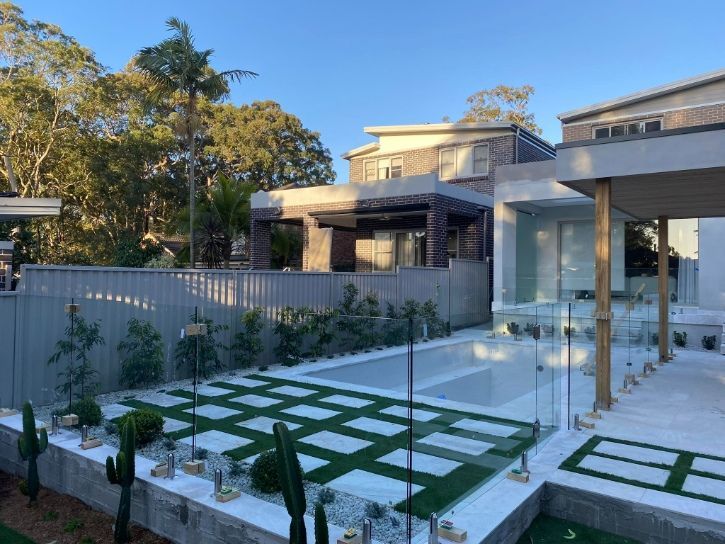 There is a large swimming pool in the backyard of a house — Fast Glass & Glazing In Barraba, NSW