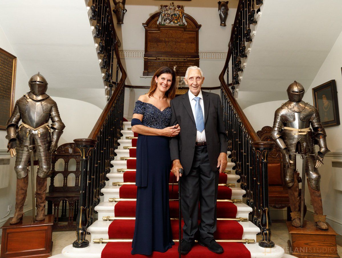 Couple at formal event having their photo taken on a staircase